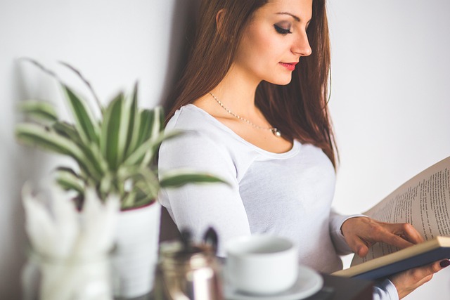 dog owner reading training guide at kitchen table